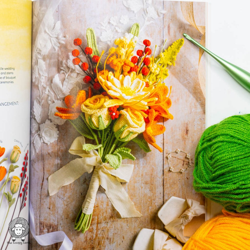 crochet bouquet from crochet a flower bouquet next to some yarn and a furls crochet hook