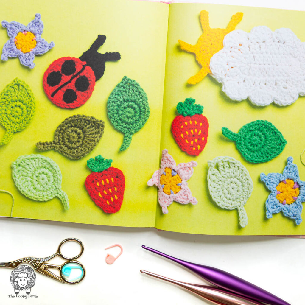 book open to show various crochet appliques from the book.