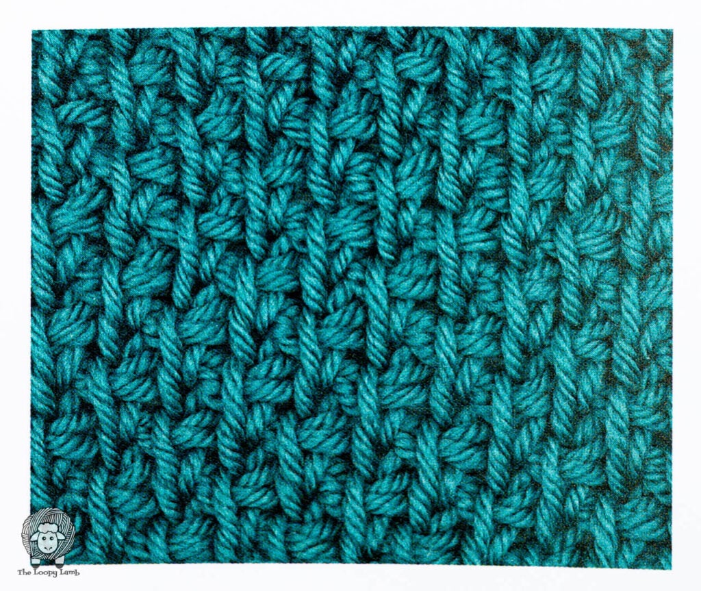 tunisian crochet stitch sample done in teal yarn from the book being reviewed.