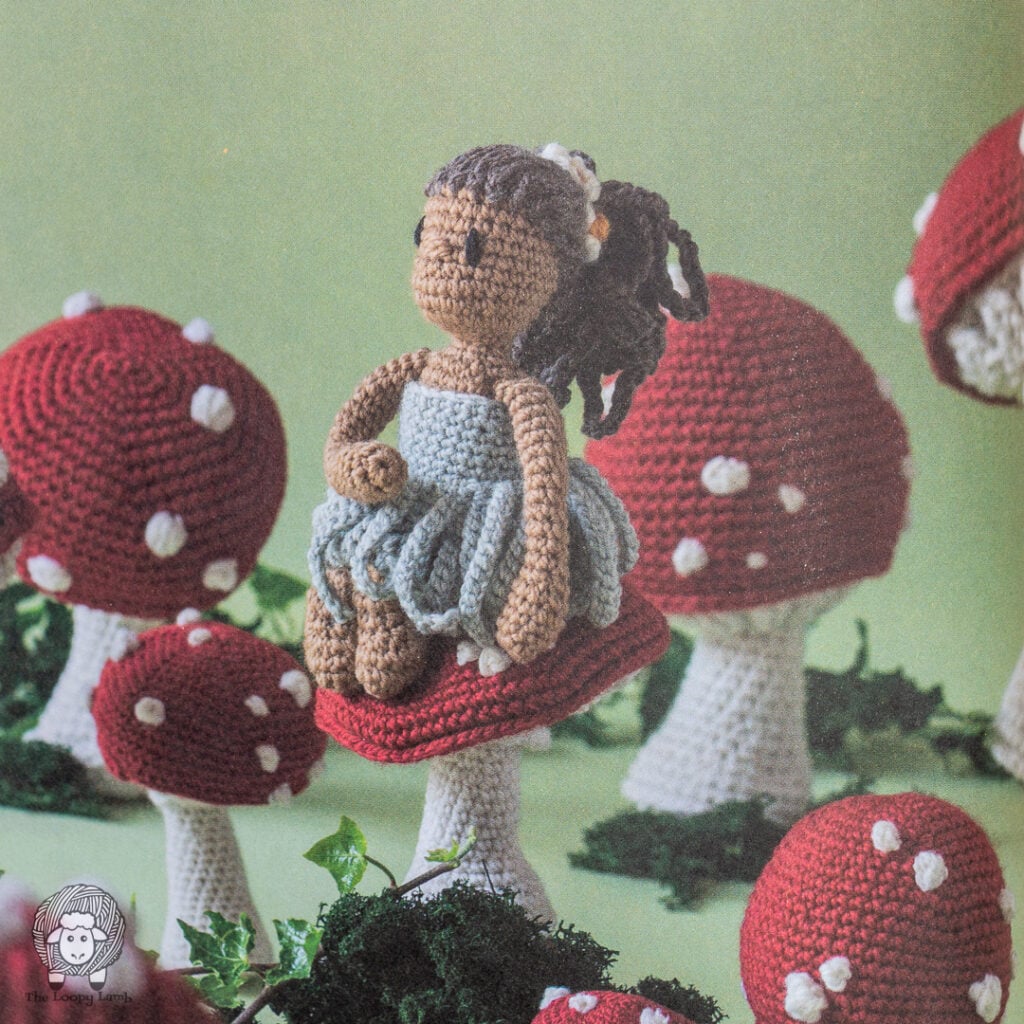 crochet Thumbelina sitting on a crochet toadstool from Crochet Fairy Tales Cottage Stories