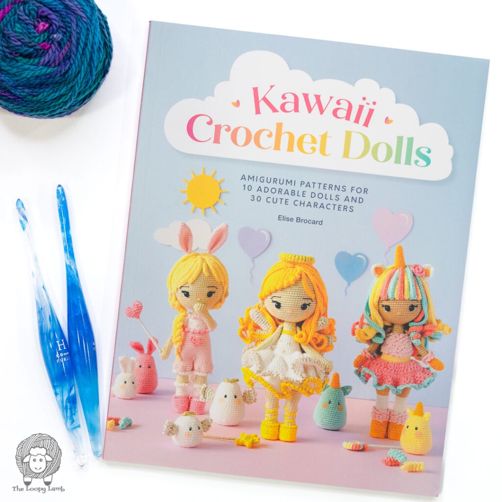 Kawaii Crochet Dolls by Elise Brochard on a white background next to 2 blue Furls crochet hooks and some yarn