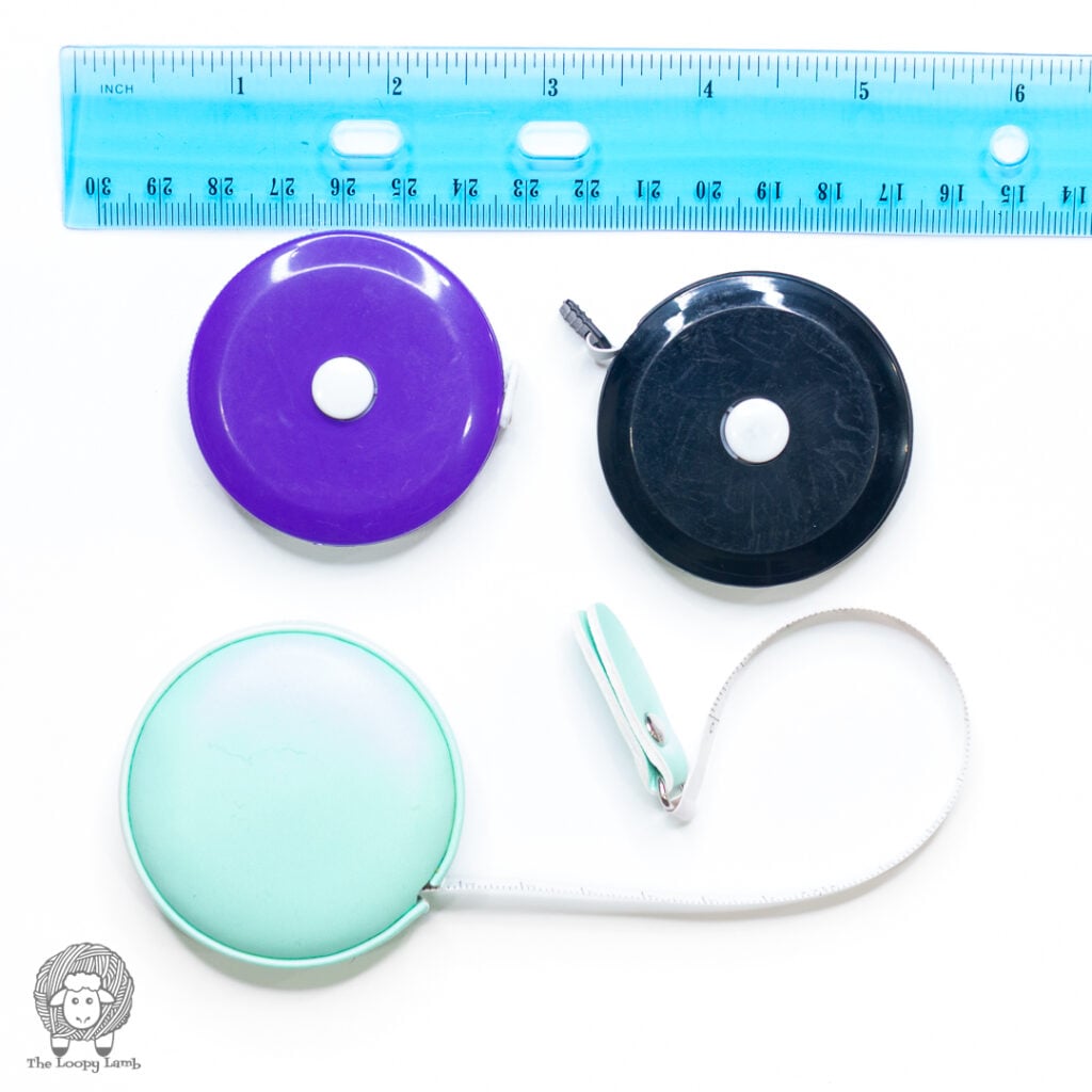 crochet tools for beginners - essentials - three different flexible tape measures and a ruler on a white background