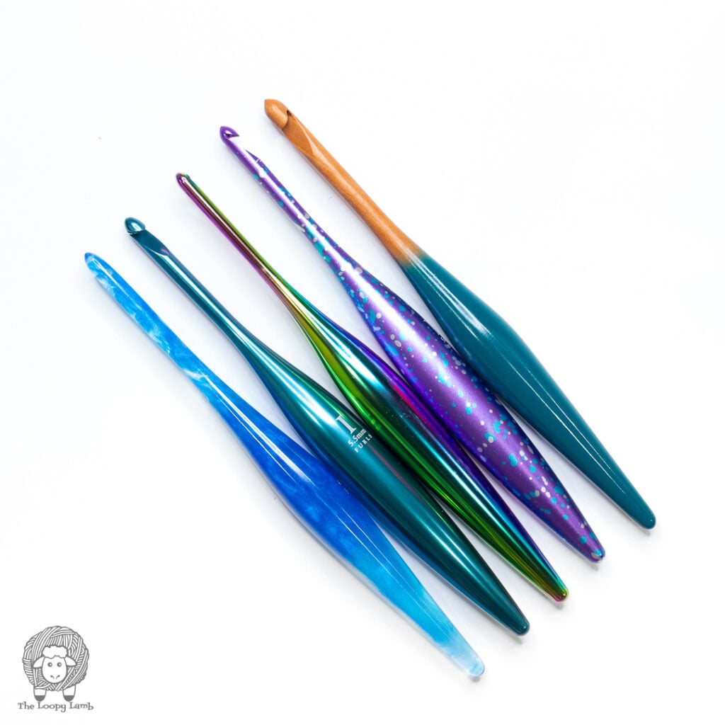 5 different Furls ergonomic crochet hooks against a white background
