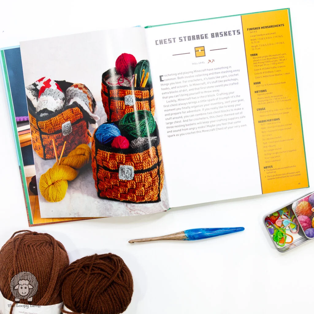 book open to show crochet chest storage baskets next to yarn and a crochet hook