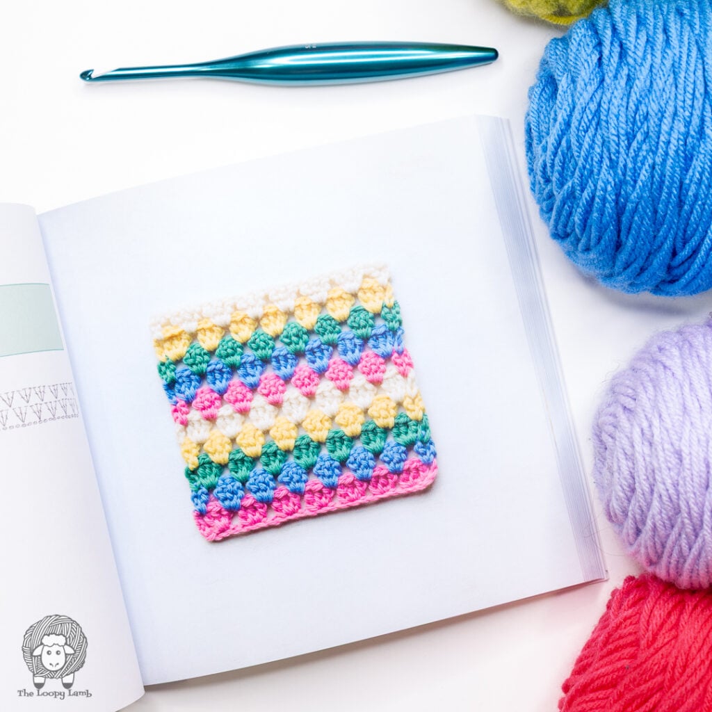granny stripe stitch square from the book next to a furls crochet hook and yarn